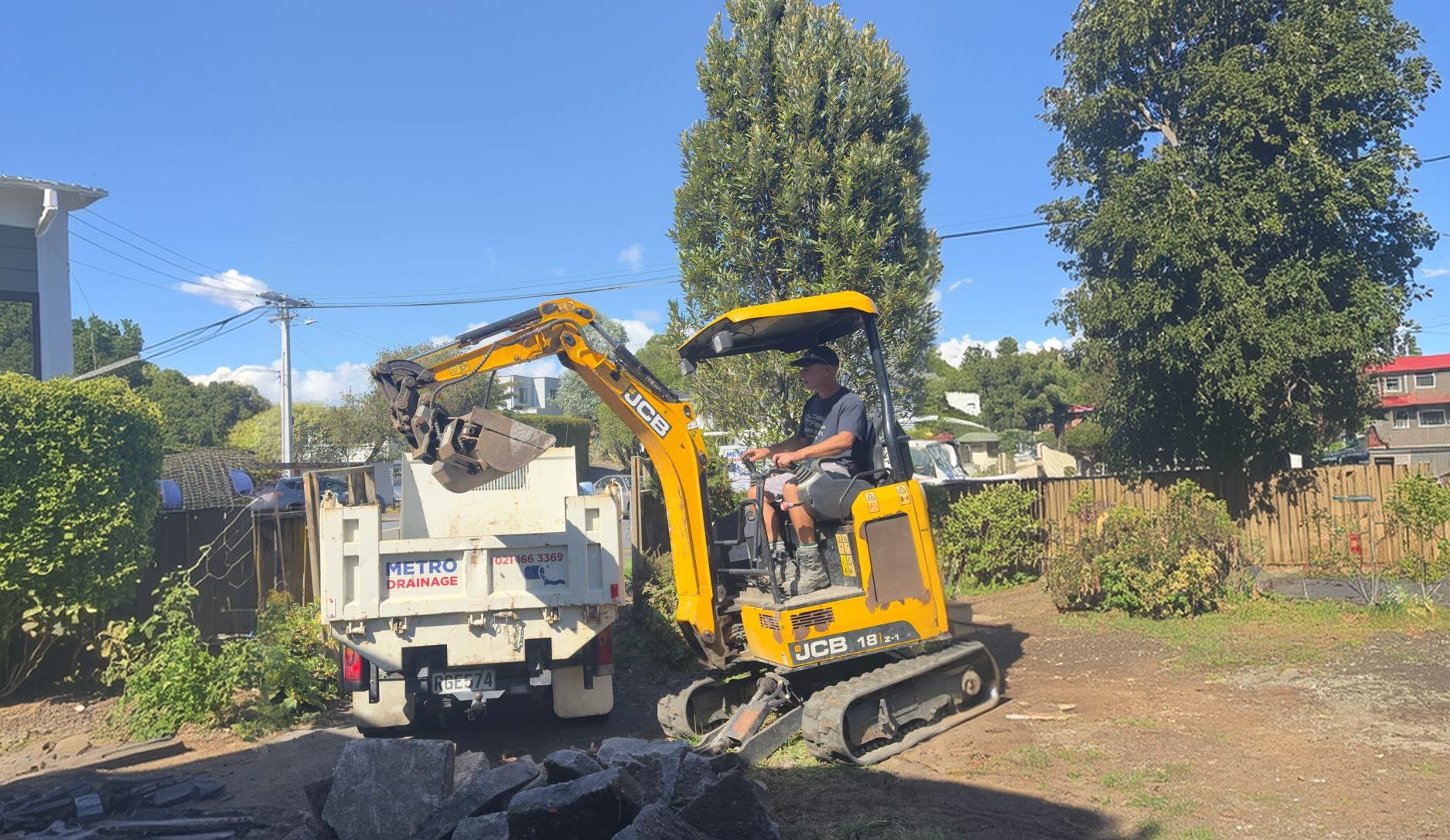 Metro Drainage digger working on an Auckland drainage site