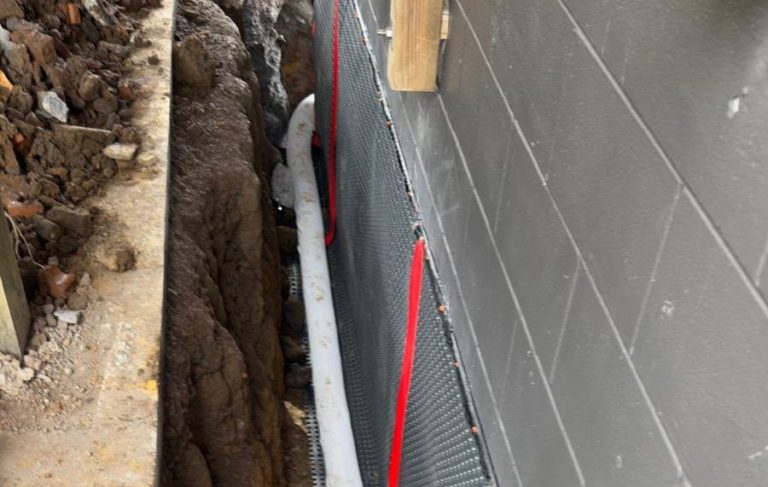 New drainage pipe installed along the side of a house
