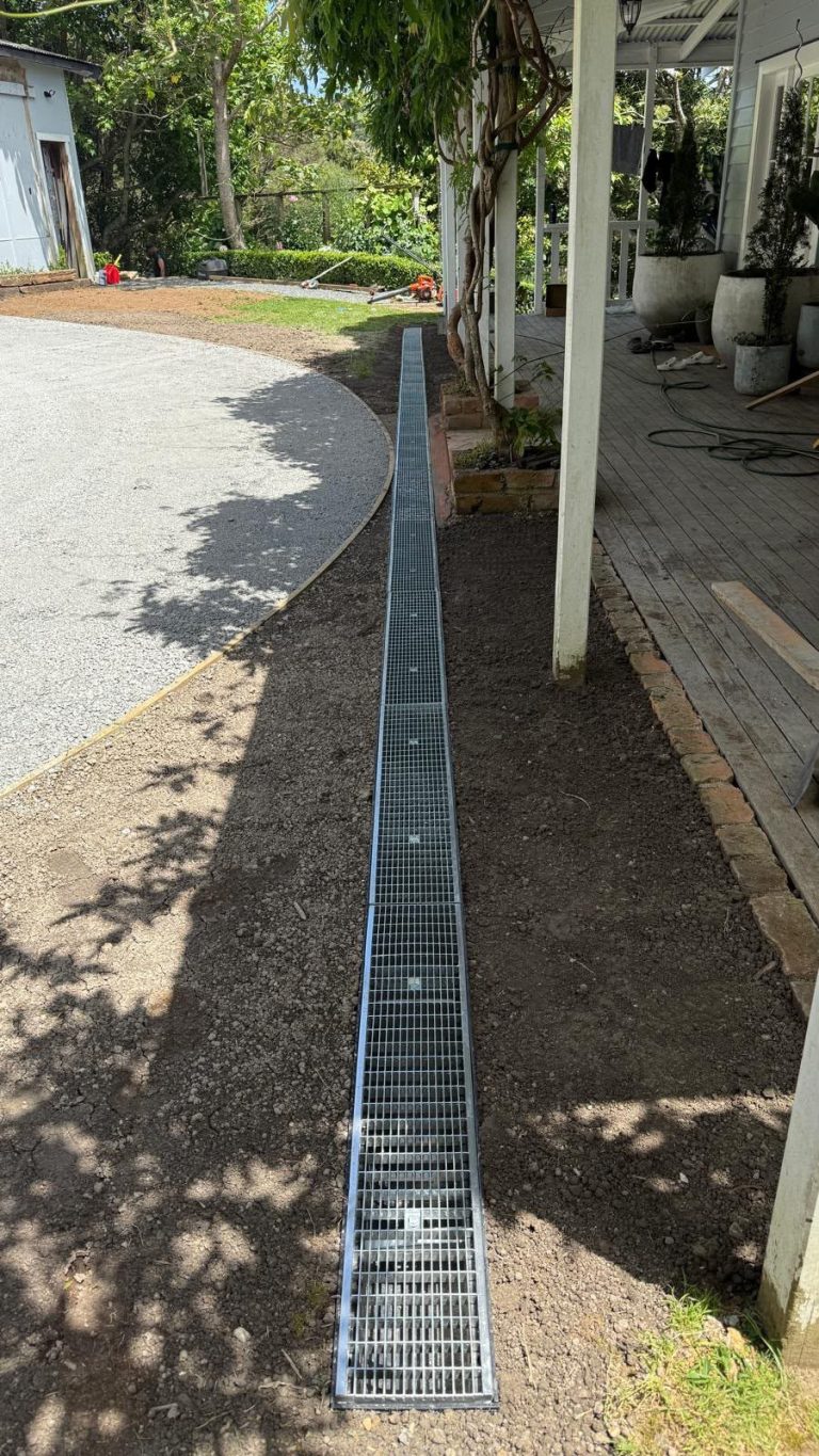 Stormwater channel drain installed along a garden path