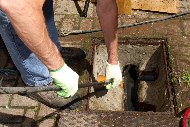 Drainlayer working on a subsoil drainage pipe in an open pit